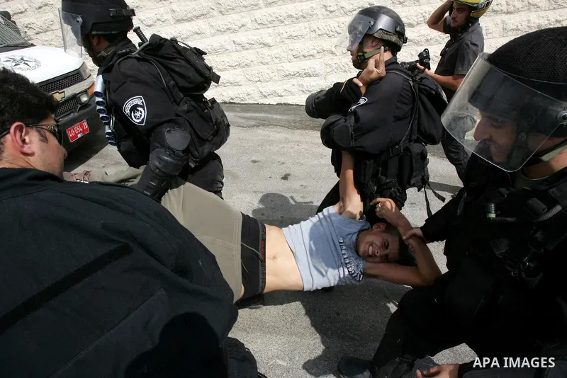 Israeli border police arrest a Palestinian youth for throwing stones at their checkpoint in Ras al-Amud neighborhood of East Jerusalem, Friday Sept. 23, 2011, just hours before their president, Mahmoud Abbas, was to deli...