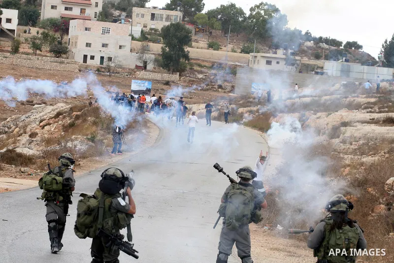 Israeli soldiers fire teargas during a clash with Palestinians in at a weekly protest in the West Bank village of Nabi Saleh, near Ramallah September 23, 2011. Israeli security forces were on high alert after Friday pray...