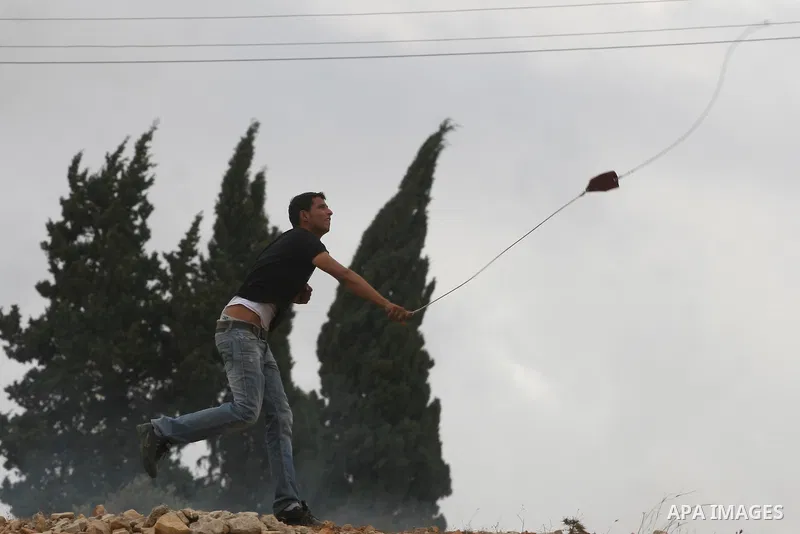 Palestinians throw stones during a clash with Israeli forces in the West Bank village of Nabi Saleh, near Ramallah September 23, 2011. Israeli security forces were on high alert after Friday prayers at a major Muslim mos...