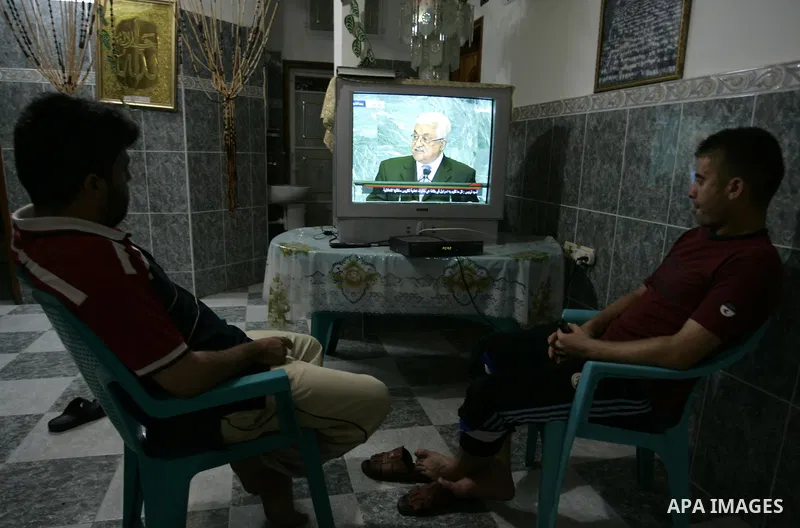 Palestinians watch the President Mahmoud Abbas on TV as he addresses the General Assembly of the United Nations at their house in the Rafah refugee camp, southern Gaza Strip Friday, Sept. 23, 2011. Photo by Abed Rahim Kh...