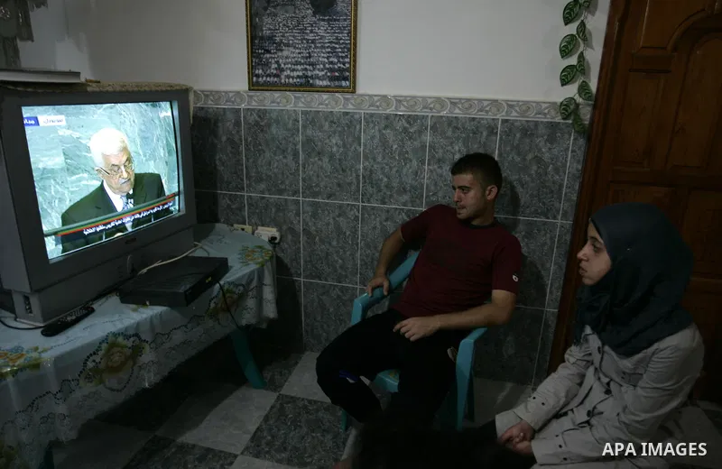 Palestinians watch the President Mahmoud Abbas on TV as he addresses the General Assembly of the United Nations at their house in the Rafah refugee camp, southern Gaza Strip Friday, Sept. 23, 2011. Photo by Abed Rahim Kh...