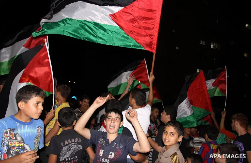 Palestinian Fatah party supporters wave their national flag in support to the President Mahmoud Abbas during a rally after he addressed the General Assembly of the United Nations in Gaza city Friday, Sept. 23, 2011. Phot...