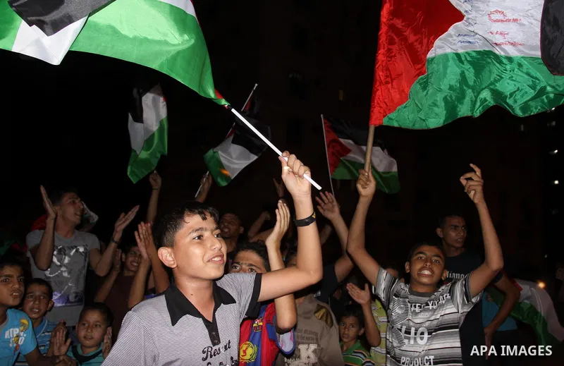 Palestinian Fatah party supporters wave their national flag in support to the President Mahmoud Abbas during a rally after he addressed the General Assembly of the United Nations in Gaza city Friday, Sept. 23, 2011. Phot...