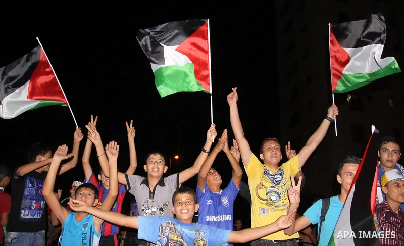 Palestinian Fatah party supporters wave their national flag in support to the President Mahmoud Abbas during a rally after he addressed the General Assembly of the United Nations in Gaza city Friday, Sept. 23, 2011. Phot...