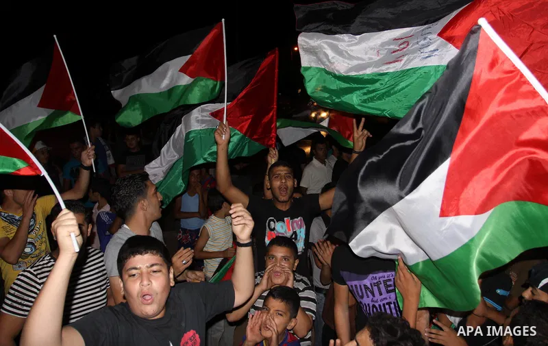 Palestinian Fatah party supporters wave their national flag in support to the President Mahmoud Abbas during a rally after he addressed the General Assembly of the United Nations in Gaza city Friday, Sept. 23, 2011. Phot...