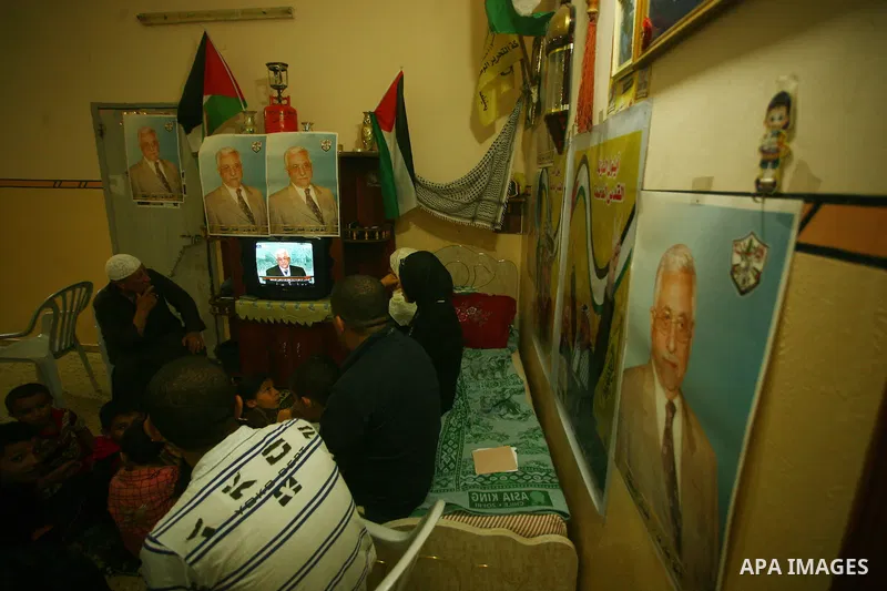 A Palestinian family watches as their president Mahmud Abbas addresses the General Assembly of the United Nations, in Gaza City on September 23, 2011 where he called on the UN to admit a state of Palestine as a full memb...
