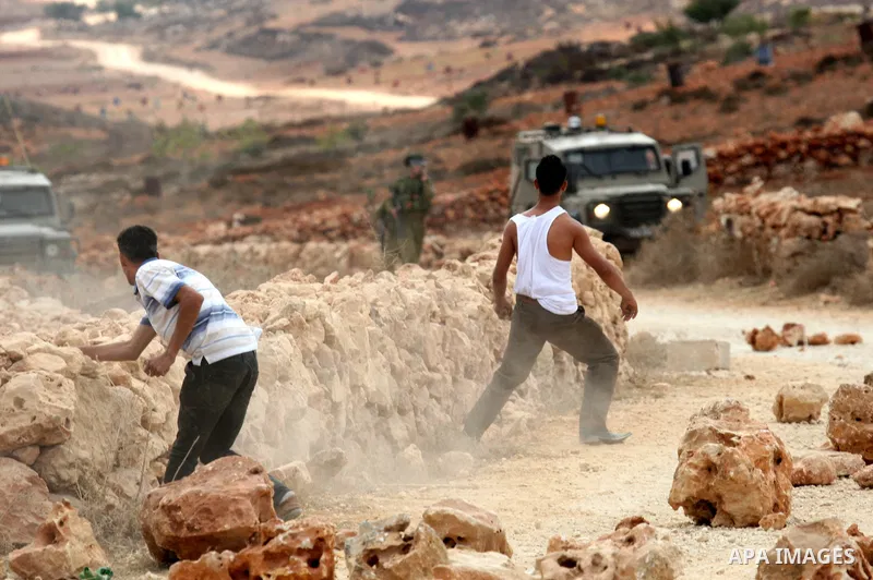 Israeli troops clash with Palestinian stone throwers in the West Bank village of Qusra, south of Nablus, on September 23, 2011. A Palestinian man was shot dead by Israeli troops in clashes which erupted after settlers at...