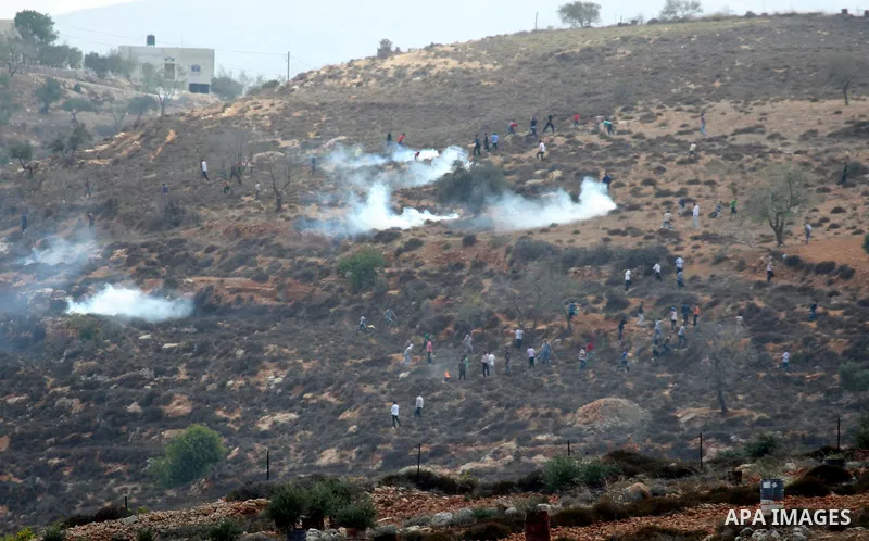 Israeli troops clash with Palestinian stone throwers in the West Bank village of Qusra, south of Nablus, on September 23, 2011. A Palestinian man was shot dead by Israeli troops in clashes which erupted after settlers at...