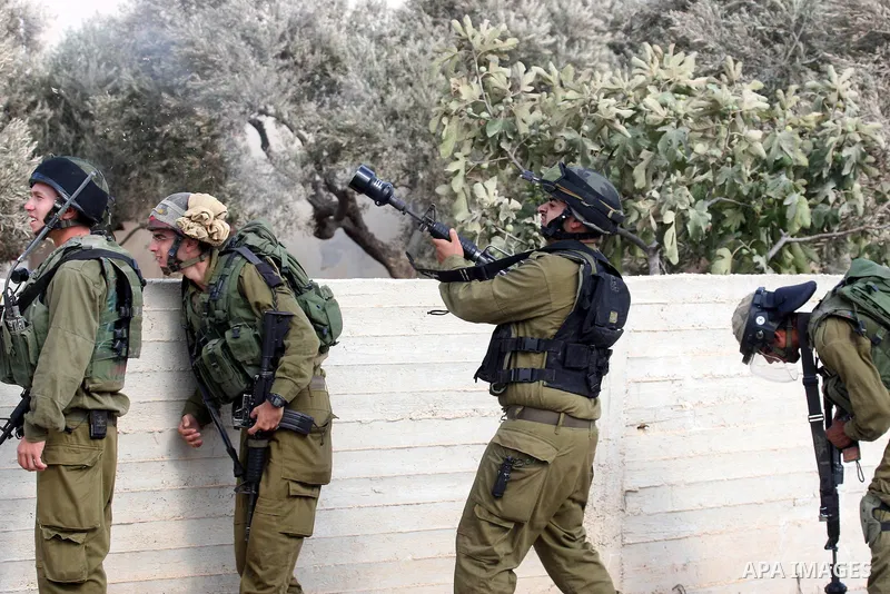 Israeli troops clash with Palestinian stone throwers in the West Bank village of Qusra, south of Nablus, on September 23, 2011. A Palestinian man was shot dead by Israeli troops in clashes which erupted after settlers at...