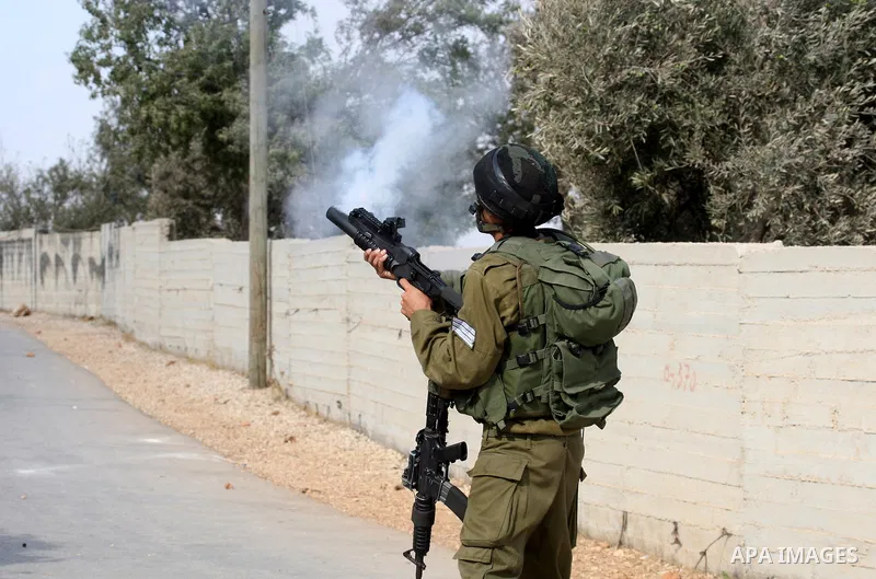 Israeli troops clash with Palestinian stone throwers in the West Bank village of Qusra, south of Nablus, on September 23, 2011. A Palestinian man was shot dead by Israeli troops in clashes which erupted after settlers at...