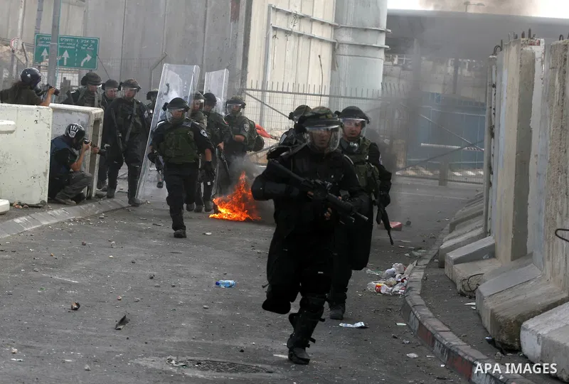 Israeli soldiers take a position during clashes with Palestinian men at the Qalandia checkpoint near Ramallah, on 23 September 2011. Reports state that Israeli security services were on high alert across the country, poi...