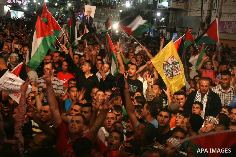 Palestinians attend a public screening of Palestinian President Mahmoud Abbas' speech at the United Nations, in the West Bank city of Ramallah September 23, 2011. Abbas asked the United Nations on Friday to recognize a s...