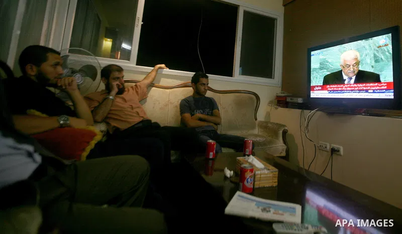 Palestinians watch a television broadcast of Palestinian President Mahmoud Abbas speaking at the United Nations in New York, in Gaza City September 23, 2011. Abbas asked the United Nations on Friday to recognize a state...
