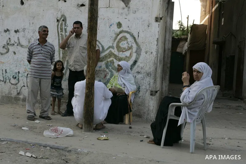 Palestinians sit outside their houses in Rafah refugee camp, southern Gaza Strip on Sep. 24, 2011. Palestinian Authority President Mahmoud Abbas, hands over a formal letter to be admitted as a state to the UN Secretary-G...