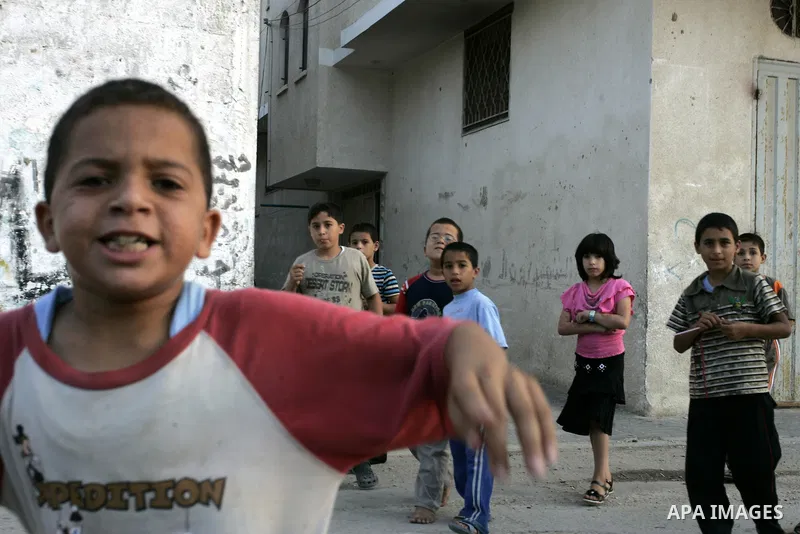 Palestinian children play outside their houses in Rafah refugee camp, southern Gaza Strip on Sep. 24, 2011. Palestinian Authority President Mahmoud Abbas, hands over a formal letter to be admitted as a state to the UN Se...