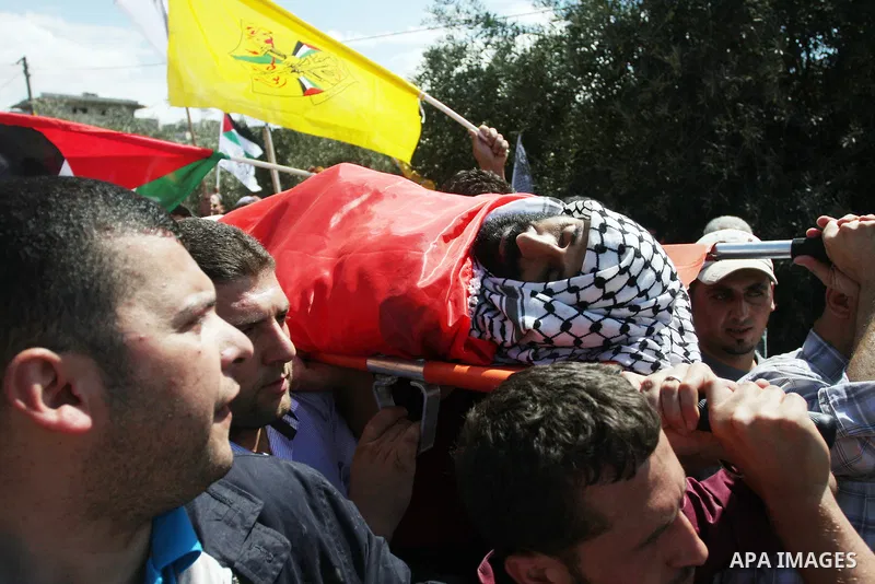 Palestinians carry the body of Essam Kamal during his funeral in the West Bank village of Qusra near Nablus September 24, 2011. Israeli security forces shot dead Kamal in the West Bank on Friday during a confrontation in...