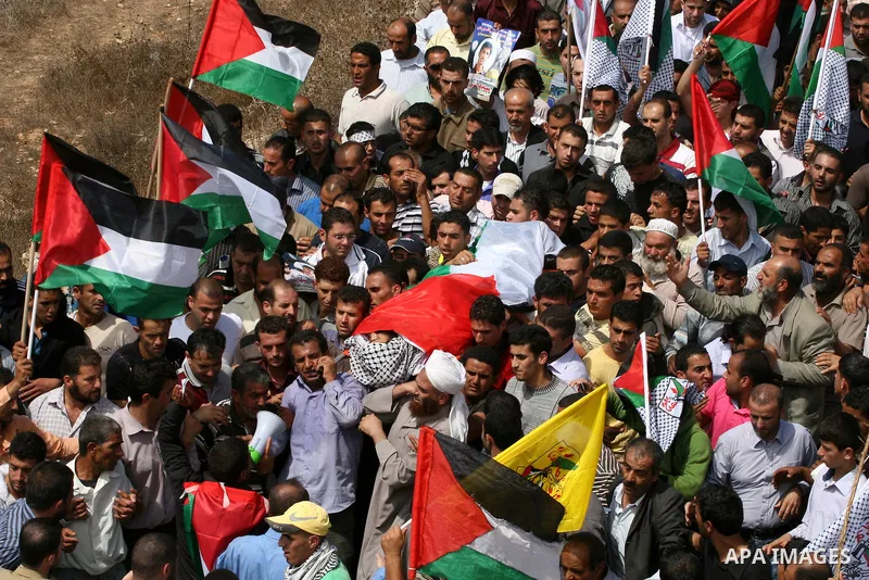Palestinian mourners carry the body of Issam Badran during his funeral in the West Bank village of Qusra near Nablus, on Sept. 24, 2011. The 37-year-old Issam Badran was wounded by Israeli forces during a demonstration i...