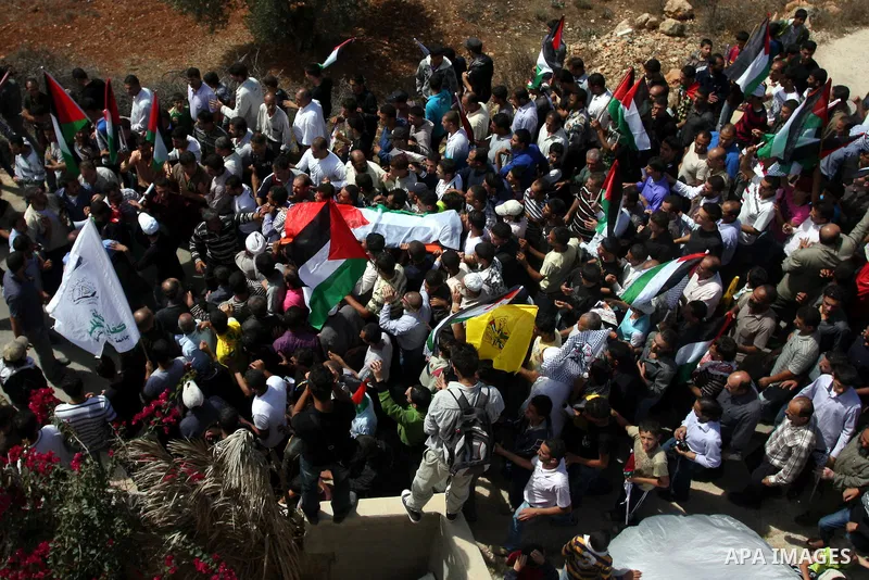 Palestinian mourners carry the body of Issam Badran during his funeral in the West Bank village of Qusra near Nablus, on Sept. 24, 2011. The 37-year-old Issam Badran was wounded by Israeli forces during a demonstration i...