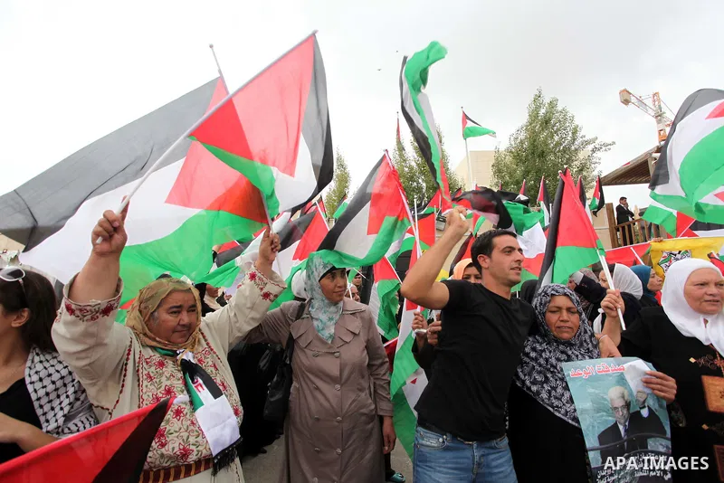 Thousands of cheering Palestinians welcome their president Mahmud Abbas outside his Ramallah headquarters on Sept. 25, 2011, as he returned from delivering a historic UN membership bid. Photo by Issam Rimawi