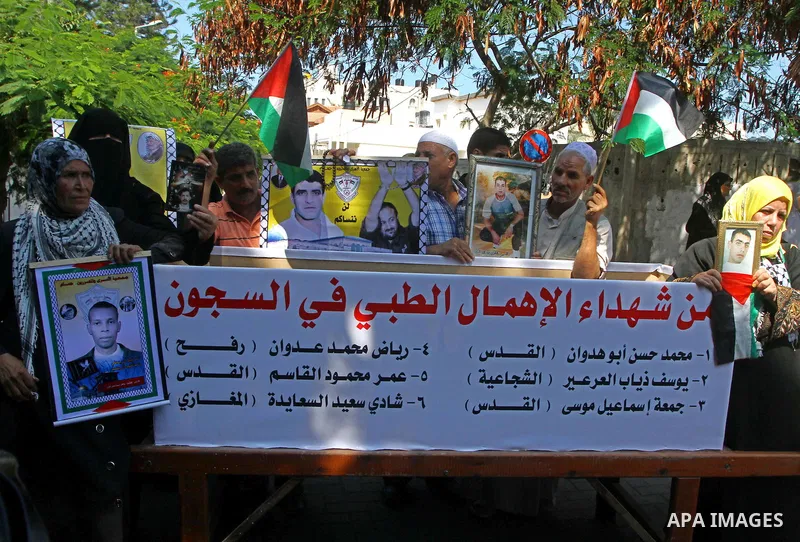 Palestinian women hold pictures of their prisoned relatives in Israeli jails infront of the UNSCO headquarters in Gaza City on Sep. 26, 2011. About 7000 prisoners are in Israeli jails according to the Palestinian prisone...