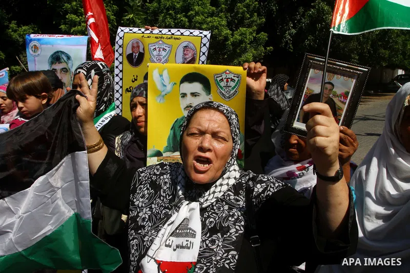 Palestinian women hold pictures of their prisoned relatives in Israeli jails infront of the UNSCO headquarters in Gaza City on Sep. 26, 2011. About 7000 prisoners are in Israeli jails according to the Palestinian prisone...