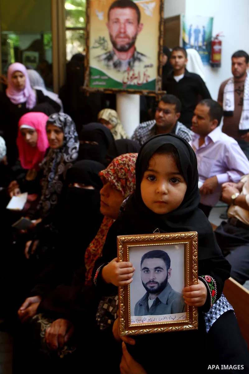 Palestinian women hold pictures of their prisoned relatives in Israeli jails as they gather in a weekly activity calling for their liberty at the Red Cross headquarters in Gaza City on Sep. 26, 2011. About 7000 prisoners...