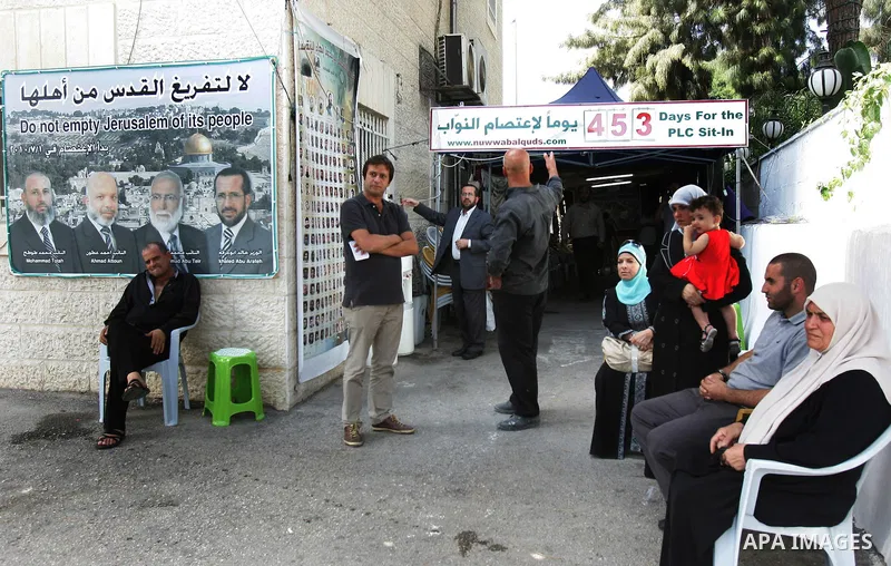 Palestinians stand at the Red Cross compound in east Jerusalem on September 26, 2011, after the member of Hamas legislative council, Ahmad Atun was arrested in an operation by undercover police officers. Atun is one of t...