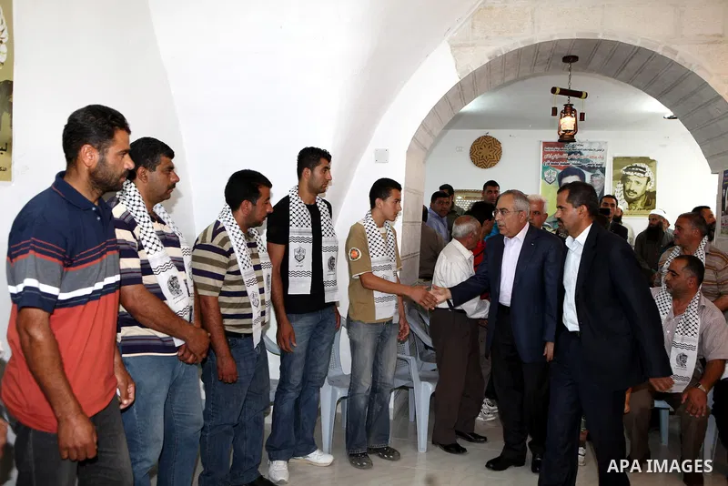 Palestinian Prime Minister, Salam Fayyad visits the family of the killed farmer Issam Badran who shot dead by Israeli troops in clashes which erupted after settlers attacked his village, in the West Bank village of Qusra...