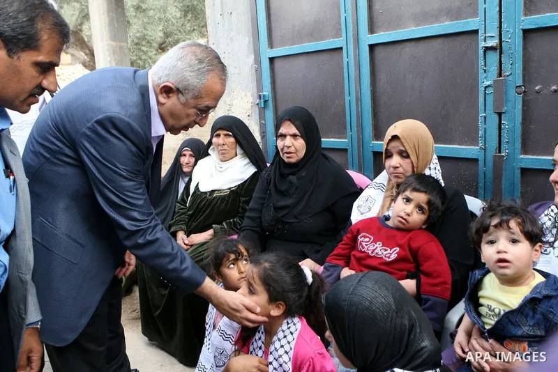 Palestinian Prime Minister, Salam Fayyad visits the family of the killed farmer Issam Badran who shot dead by Israeli troops in clashes which erupted after settlers attacked his village, in the West Bank village of Qusra...