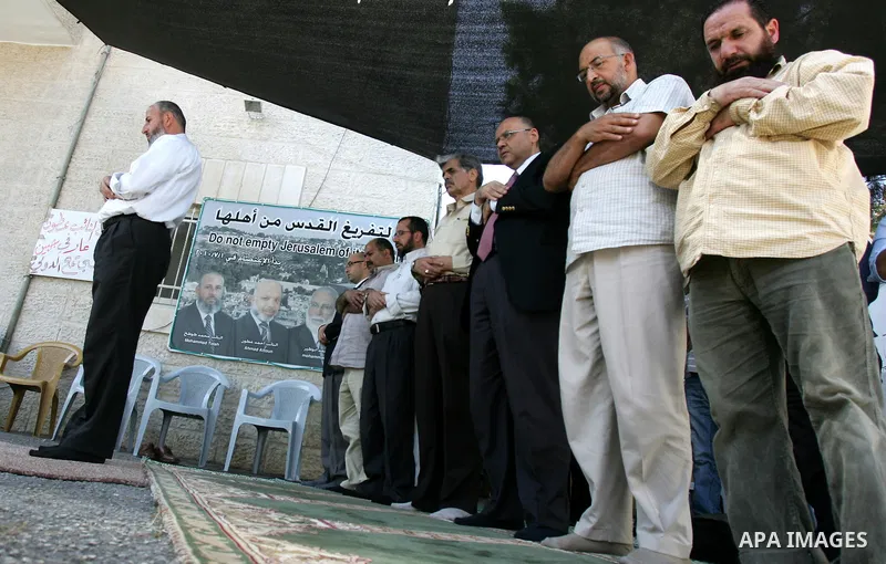 Members of Palestinians Hamas legislators, pray during a protest at the Red Cross compound in east Jerusalem on September 27, 2011, after the member of Hamas legislative council, Ahmad Atun was arrested in an operation b...