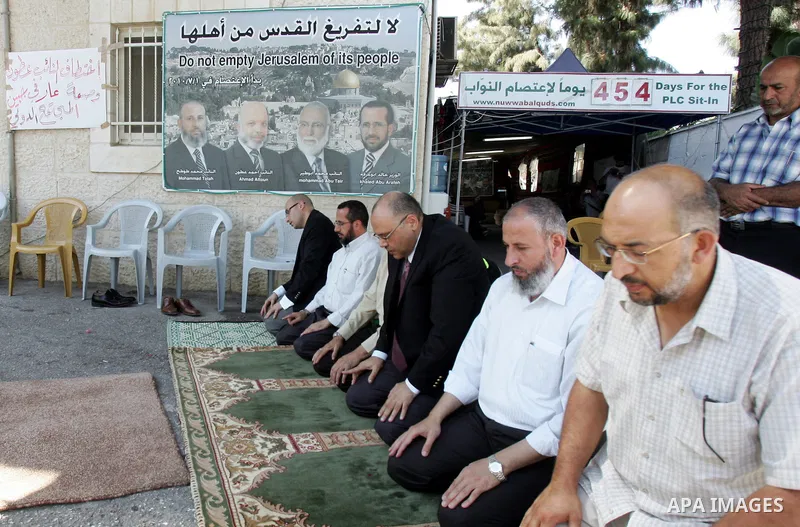 Members of Palestinians Hamas legislators, pray during a protest at the Red Cross compound in east Jerusalem on September 27, 2011, after the member of Hamas legislative council, Ahmad Atun was arrested in an operation b...