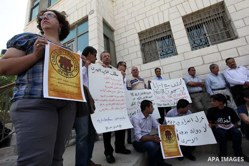 Relatives of Palestinians held in Israeli jails demonstrate in front of the Red Cross headquarters in Ramallah in support of the prisoners' first day of hunger strike on Sep. 28, 2011. Photo by Issam Rimawi