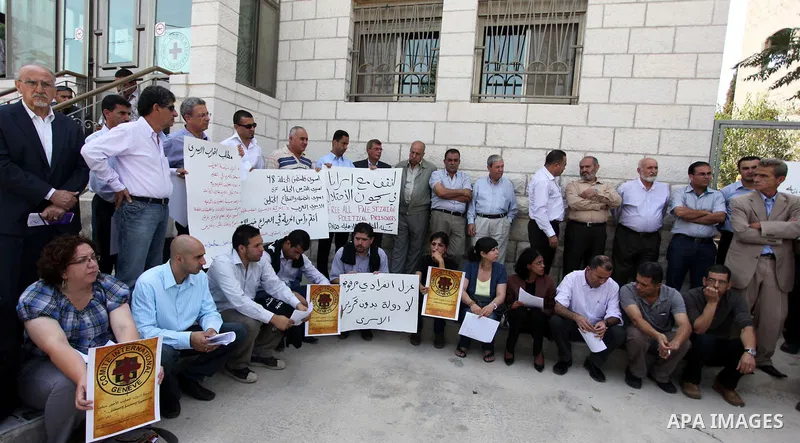 Relatives of Palestinians held in Israeli jails demonstrate in front of the Red Cross headquarters in Ramallah in support of the prisoners' first day of hunger strike on Sep. 28, 2011. Photo by Issam Rimawi