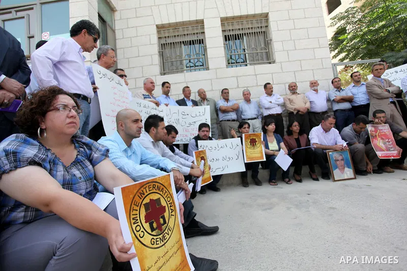 Relatives of Palestinians held in Israeli jails demonstrate in front of the Red Cross headquarters in Ramallah in support of the prisoners' first day of hunger strike on Sep. 28, 2011. Photo by Issam Rimawi
