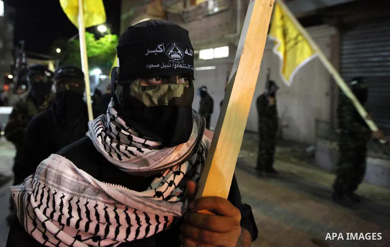 Palestinian militants of the Nabil Massud Unit of the Al-Aqsa Martyrs Brigades, an armed offshoot of the Fatah movement, march in the Jabalia refugee camp in the northern Gaza Strip on Sept. 28, 2011 as they mark the 11t...