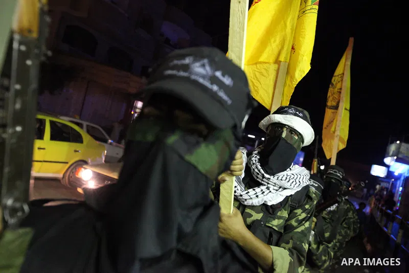 Palestinian militants of the Nabil Massud Unit of the Al-Aqsa Martyrs Brigades, an armed offshoot of the Fatah movement, march in the Jabalia refugee camp in the northern Gaza Strip on Sept. 28, 2011 as they mark the 11t...