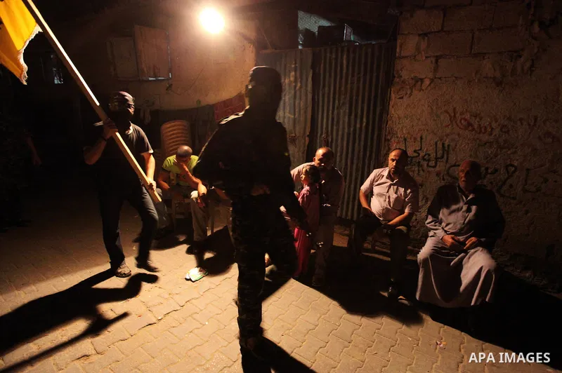 Palestinian militants of the Nabil Massud Unit of the Al-Aqsa Martyrs Brigades, an armed offshoot of the Fatah movement, march in the Jabalia refugee camp in the northern Gaza Strip on Sept. 28, 2011 as they mark the 11t...