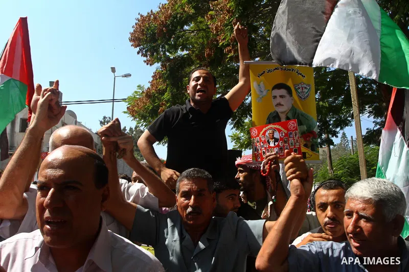 Palestinians shout slogans during a protest calling for the release of imprisoned relatives from Israeli jails outside the International Committee of the Red Cross (ICRC) in Gaza City on September 29, 2011 . Photo by Ash...