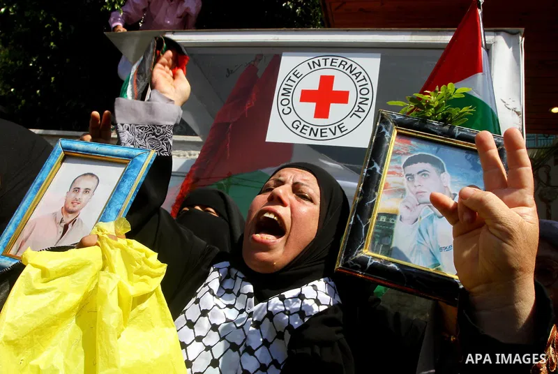 A Palestinians woman shouts slogans while holding pictures of her jailed relatives during a protest calling for their release from Israeli prisons outside the International Committee of the Red Cross (ICRC) in Gaza City...