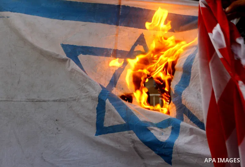 Palestinian militants of Popular Resistance Committees burn an Israeli and American flags during a rally to mark the 12th anniversary of Al-Aqsa Intifada (uprising) in Gaza city on Sept. 29,2011. Israel on Tuesday approv...
