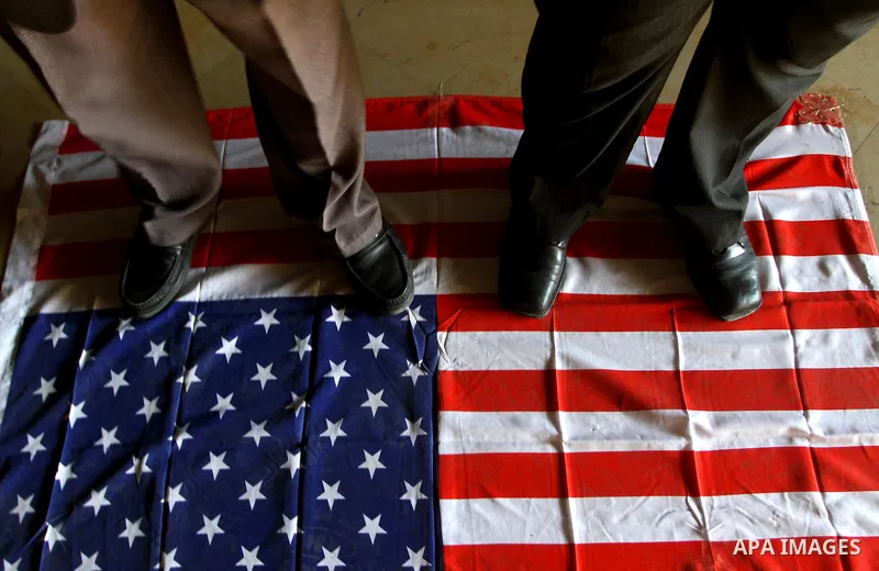 Palestinian supporters of Popular Resistance Committees step on American flag during a rally to mark the 12th anniversary of Al-Aqsa Intifada (uprising) in Gaza city on Sept. 29,2011. Israel on Tuesday approved construct...
