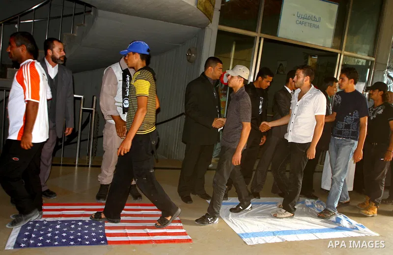 Palestinian supporters of Popular Resistance Committees step on an Israeli and American flags during a rally to mark the 12th anniversary of Al-Aqsa Intifada (uprising) in Gaza city on Sept. 29,2011. Israel on Tuesday ap...