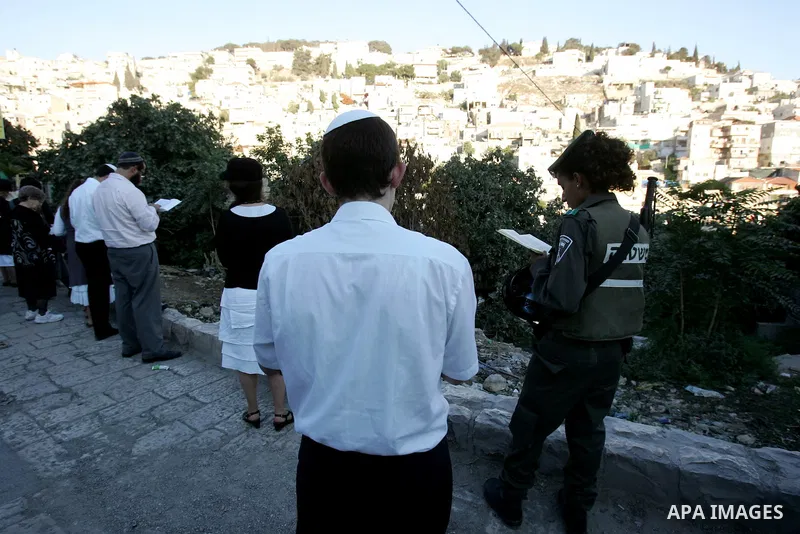 Jews gather to read prayers and perform 'Tashlich,' meaning to 'cast off,' near a small stream of water overlooking the arab East Jerusalem village of Silwan, at sun down on the first day of Jewish New Year, or Rosh Hash...