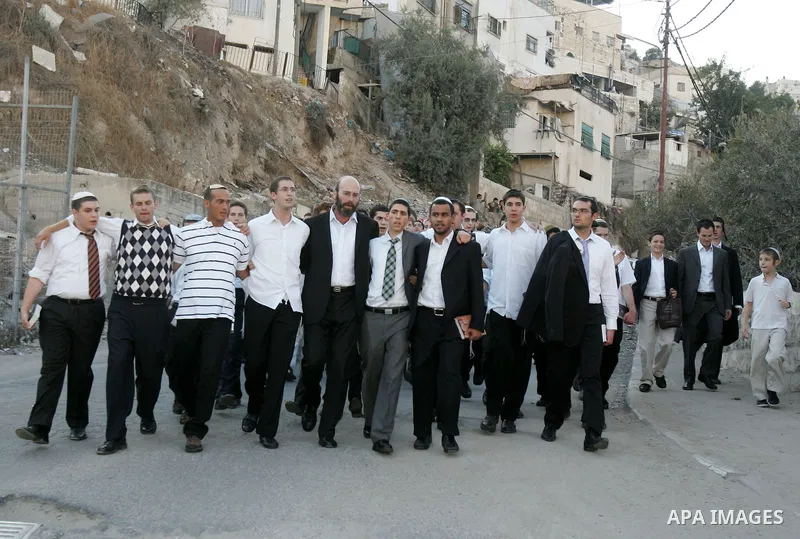 Jews gather to read prayers and perform 'Tashlich,' meaning to 'cast off,' near a small stream of water overlooking the arab East Jerusalem village of Silwan, at sun down on the first day of Jewish New Year, or Rosh Hash...