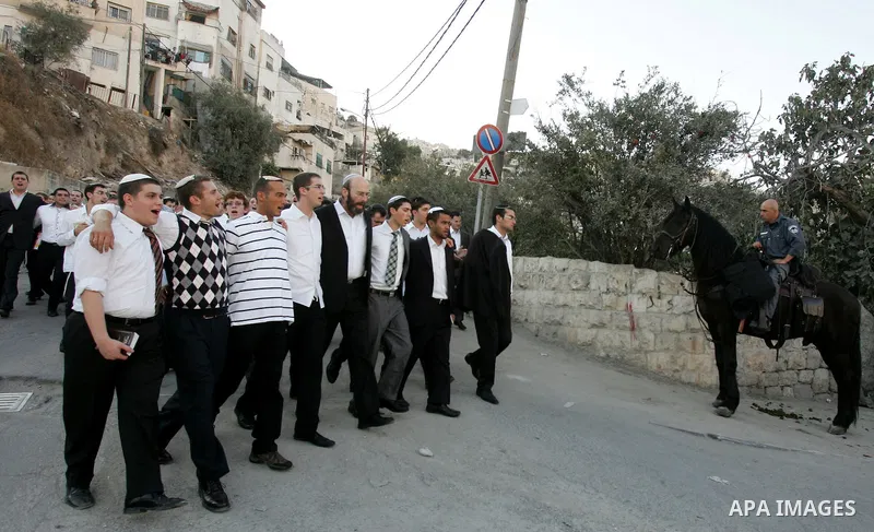 Jews gather to read prayers and perform 'Tashlich,' meaning to 'cast off,' near a small stream of water overlooking the arab East Jerusalem village of Silwan, at sun down on the first day of Jewish New Year, or Rosh Hash...