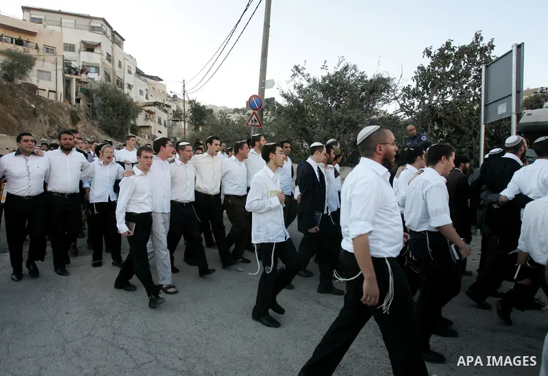Jews gather to read prayers and perform 'Tashlich,' meaning to 'cast off,' near a small stream of water overlooking the arab East Jerusalem village of Silwan, at sun down on the first day of Jewish New Year, or Rosh Hash...
