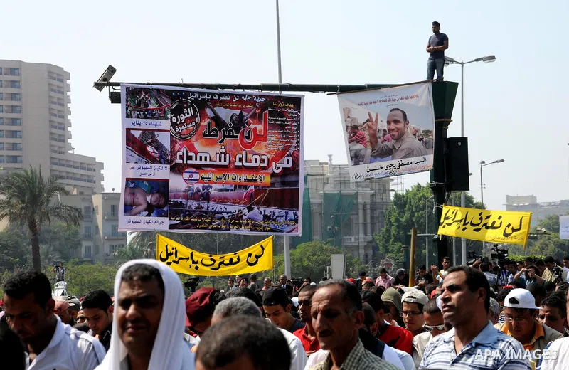 Egyptian demonstrators hold banners during a protest at Tahrir Square in Cairo, Egypt, Friday, Sept. 30, 2011. Several thousand Egyptians are protesting against the country's military ruler's decision to retain the much...