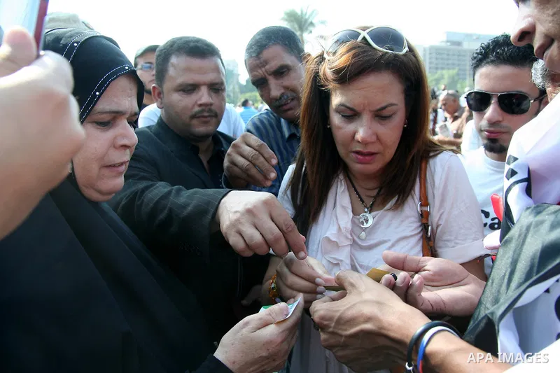 An Egyptian candidate for the presidential elections, Buthina Kamel takes part in a protest at Tahrir Square in Cairo, Egypt, Friday, Sept. 30, 2011. Several thousand Egyptians are protesting against the country's milita...