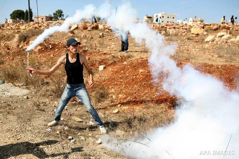 Palestinian youths clash with Israeli forces following a weekly demonstration against Israeli settlement expansion, in the West Bank village of Nabi Saleh, near the Jewish settlement of Halamish on September 30, 2011. Ph...