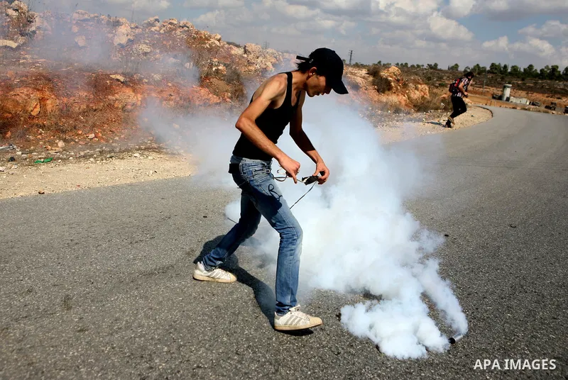 Palestinian youths clash with Israeli forces following a weekly demonstration against Israeli settlement expansion, in the West Bank village of Nabi Saleh, near the Jewish settlement of Halamish on September 30, 2011. Ph...